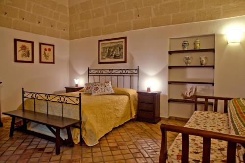 a bedroom with a bed and a table and shelves at Agriturismo La Stornara in Ginosa Marina