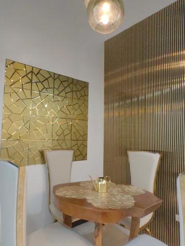 a dining room with a wooden table and chairs at Luna Modern Guesthouse Loft House up and Down in Lipa