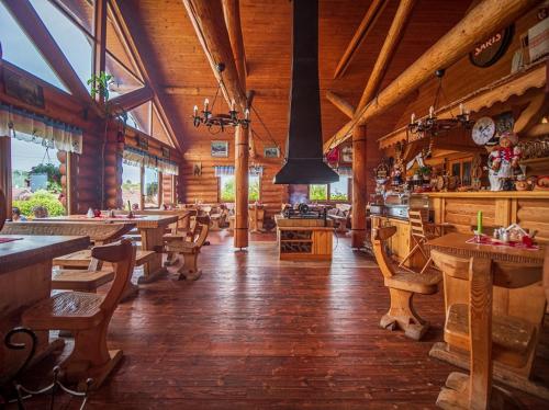 a restaurant with wooden tables and chairs in a building at Apartmán Lesana in Nová Lesná