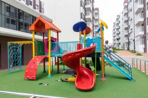 a childrens playground with a slide and a slideintend at 2 Bedroom Aries Residence, Mbsa Rd in Nairobi