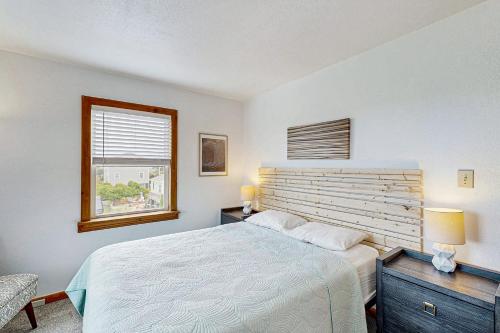 a bedroom with a large bed and a window at Tarpon Drive Hideaway MASTER in Avon