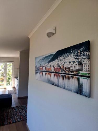 a painting hanging on a wall in a living room at Levadinha - Nature guest house in Madalena do Mar