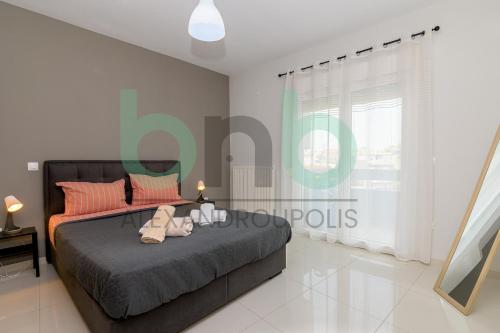 a bedroom with a bed with two stuffed animals on it at Luxurious Tsimiski 3BDR 3rd Floor in Alexandroupoli