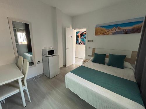 Postel nebo postele na pokoji v ubytování Hostal Los Mellizos