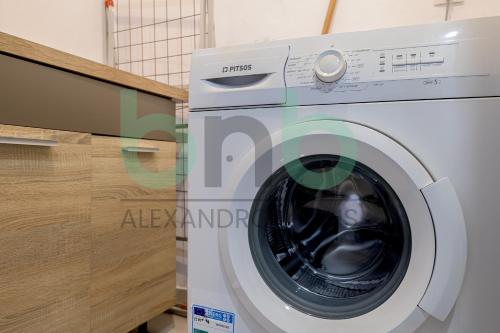 a white washing machine sitting next to a counter at Luxurious Tsimiski 3BDR 3rd Floor in Alexandroupoli