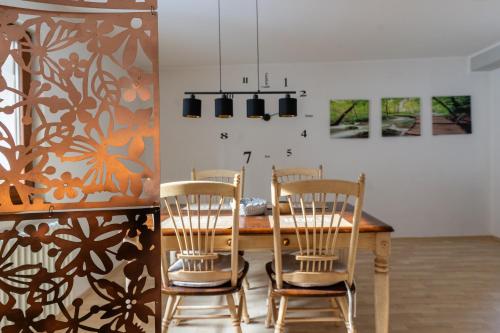 a dining room with a wooden table and chairs at VIA MALA Apartment in Kirchensittenbach