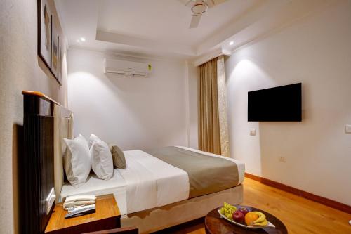 a hotel room with a bed and a television at IVA Premium Aerocity - Free Airport Pickup or Drop in New Delhi