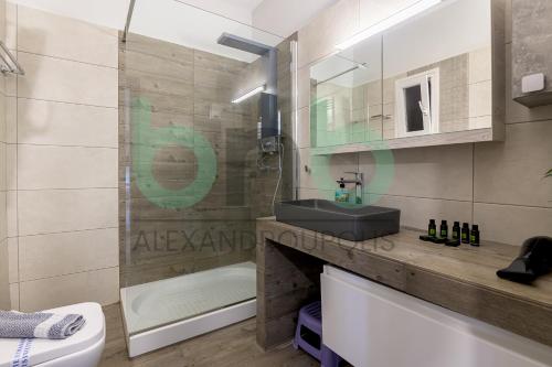 a bathroom with a sink and a shower and a toilet at Luxurious Tsimiski 3BDR 3rd Floor in Alexandroupoli