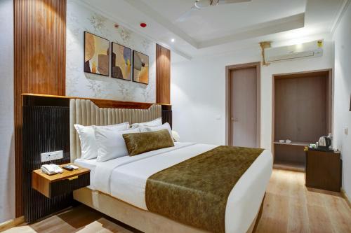 a bedroom with a large bed in a room at IVA Premium Aerocity - Free Airport Pickup or Drop in New Delhi