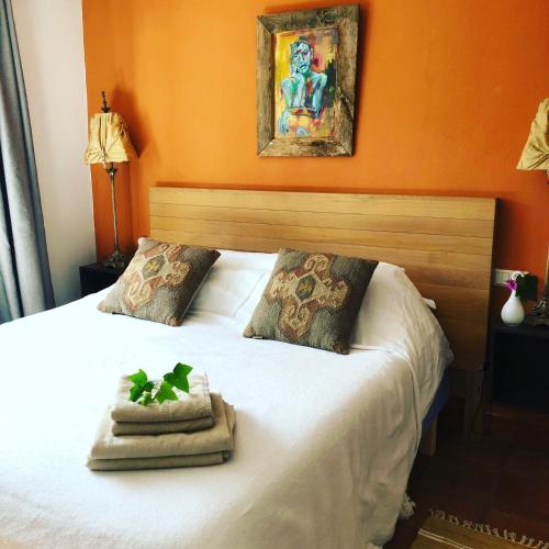 a bed with two towels and a plant on it at A natural retreat in Mijas