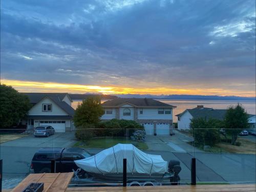a boat in a parking lot with a sunset in the background at Passage view in Campbell River
