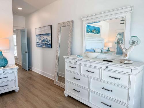 a white dresser with a mirror in a room at Serenity by the Sea St George Island Pool Home in Eastpoint