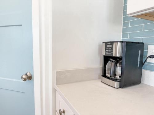 a kitchen counter with a coffee maker on top of it at Serenity by the Sea St George Island Pool Home in Eastpoint