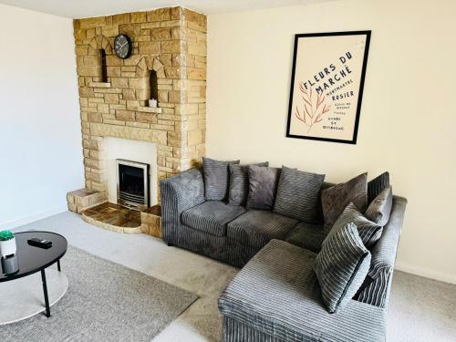 a living room with a couch and a fireplace at Professional 4BR House - Lace Market, Uni, QMC, City Centre & M1 - Sleeps 8 in Nottingham