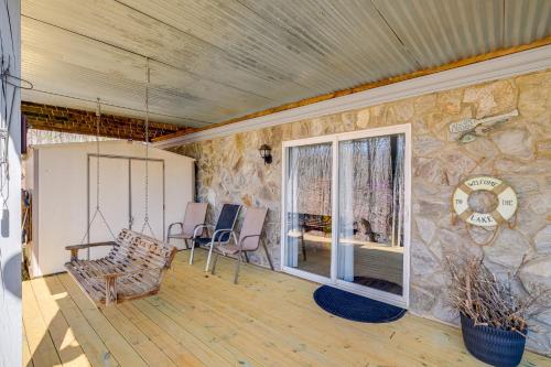 a living room with a stone wall at Fish, Boat and Hike Lakefront Home with Game Room! in Moneta