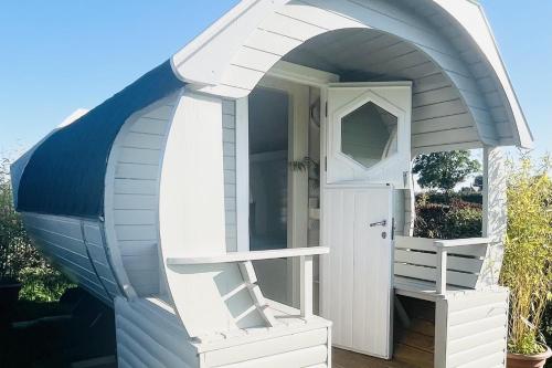 a play house with a door and a porch at Solo Glamping Pod - Sleeps 4 - Northumberland in Morpeth