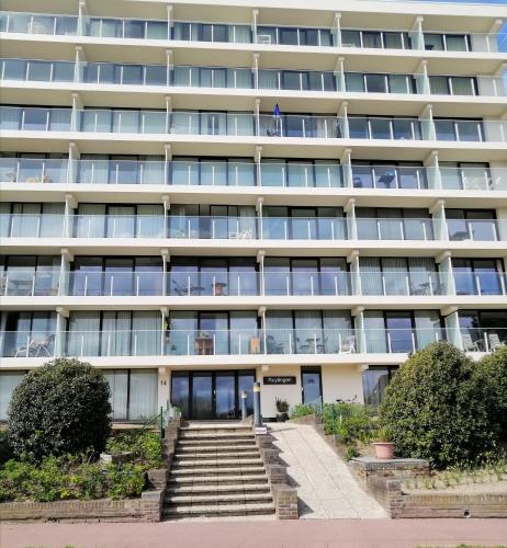 an external view of a large white building at Zee en Strand in De Panne