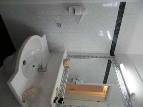 a bathroom with a white tub and a toilet at Nissiotiko Studios & Apartments in Drios