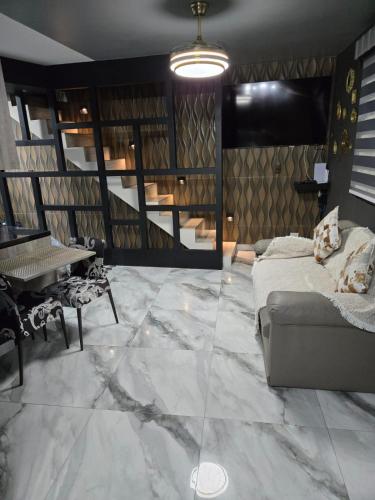 a living room with a couch and a table at Ap Carioca in Rio de Janeiro