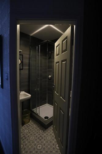a bathroom with a shower and a toilet and a door at Ferny House in Blackpool