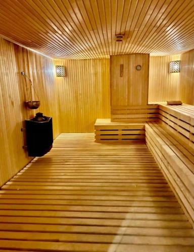 a large empty room with wooden walls and wooden floors at Luxury Suites White Sails in Batumi