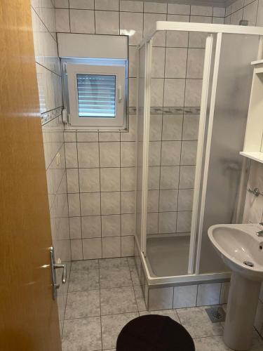 a bathroom with a shower and a sink at Apartments Žitna Sun in Vir