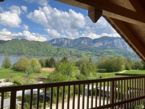 a view from the balcony of a house with a view of the mountains at Sunset am Attersee in Nussdorf am Attersee