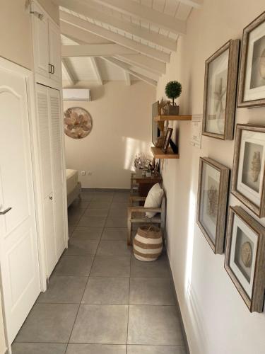 a hallway with pictures on the walls and a tile floor at Sea shell Villa in Grand Case