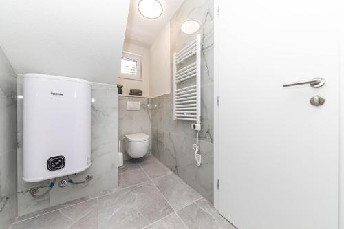 a bathroom with a shower and a toilet in it at Apartman Simic in Trogir