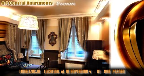 a living room with windows with curtains and a couch at Art Apartments in Poznań