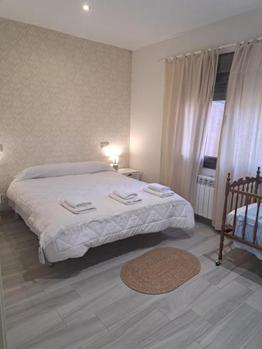 a bedroom with a large bed and a window at Casa Gabritana in Sotillo de las Palomas