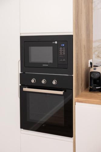 a microwave oven sitting on top of a counter at Tibi's Villa in Fushë-Krujë