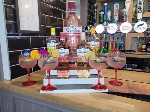 a group of wine glasses sitting on a bar at The Station Inn in Birmingham