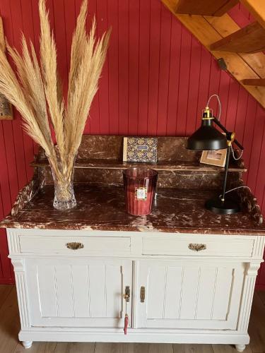 a white cabinet with feathers on top of it at " Goarem Bihan" Villa de Charme Front de Mer in Plouarzel