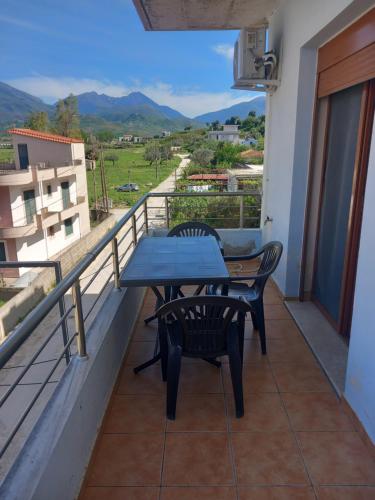 a table and chairs on a balcony with a view at Dario's Apartaments 2 in Orikum
