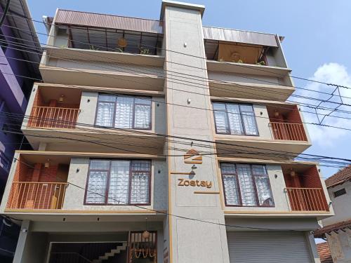 a building with balconies on the side of it at Zostay Urban Retreat Deluxe Rooms & Premium Dorms in Manjeri