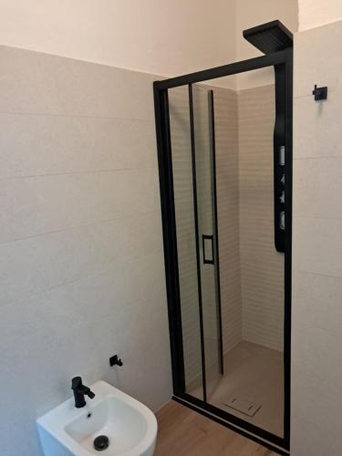 a bathroom with a sink and a mirror at Alfaro54 in Brunate