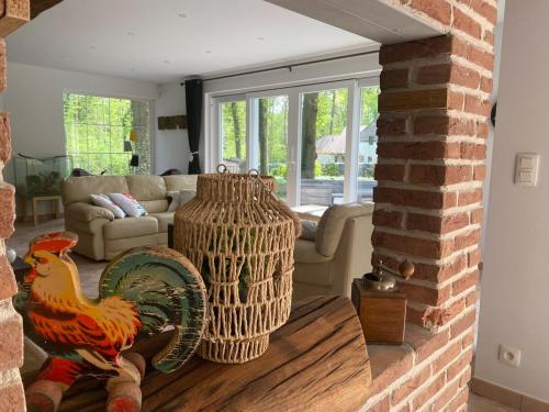a living room with a couch and a chicken statue at A Chardonnerets by La Maison de Mel in Enghien