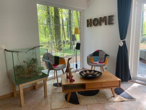 a living room with two chairs and a table at A Chardonnerets by La Maison de Mel in Enghien