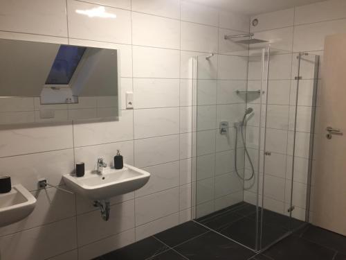 a bathroom with a sink and a shower at Villa WoW in Zastań