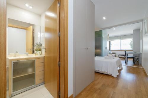 a bathroom with a sink and a bed in a room at Playa Sanxenxo in Sanxenxo