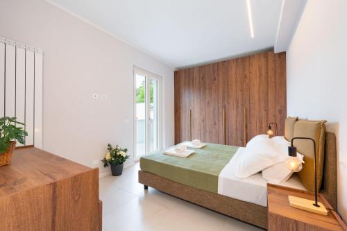 a bedroom with a bed with a wooden wall at Borgo Trento Residence in Verona