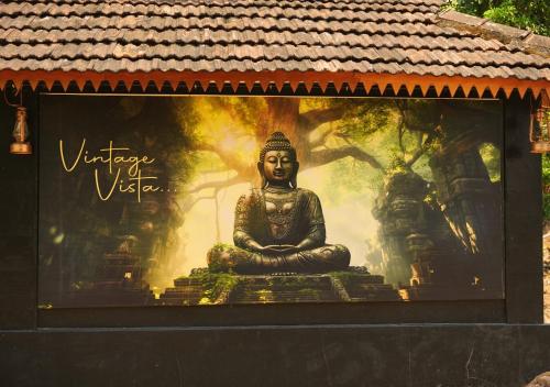 a large mural of a statue of aitating practition at Vintage Vista in Lakkidi