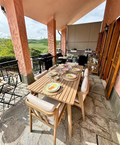 a wooden table and chairs on a patio at A casa dei Nonni in Neive
