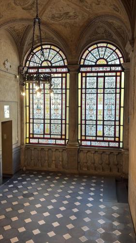 a large room with stained glass windows in a building at Hulu 2 in Savona