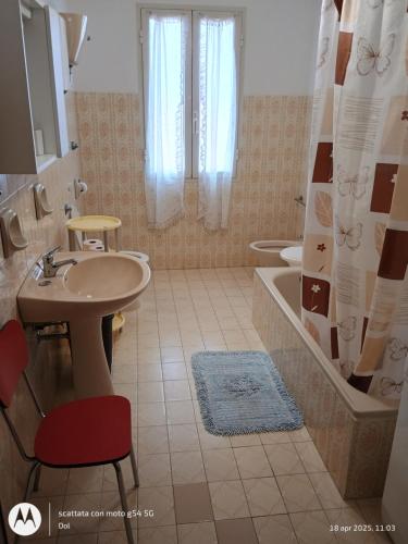 a bathroom with a sink and a toilet and a tub at La Terrazza Di Chiara in La Caletta
