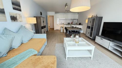 a living room with a couch and a table at OneLuxStay near Diamond District in Antwerp