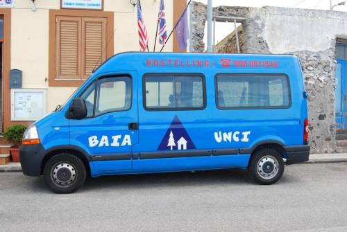 a blue van parked in front of a building at Baia Unci in Canneto
