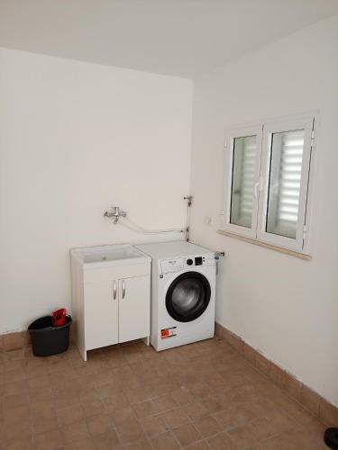 a washing machine in a bathroom with a sink at Da Margot - Appartamento al mare in Grottammare