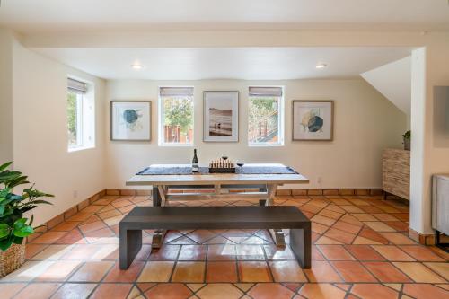 a dining room with a table and a bench at Montecito SeaRenity by Paradise Retreats in Montecito